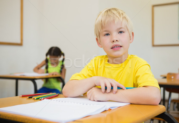 Cute pupils colouring at desks in classroom Stock photo © wavebreak_media