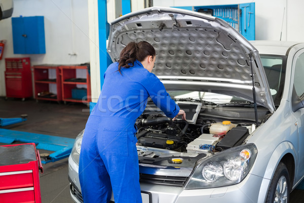 Mechanic examining under hood of car Stock photo © wavebreak_media