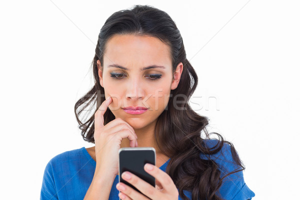 Pretty brunette sending a text Stock photo © wavebreak_media