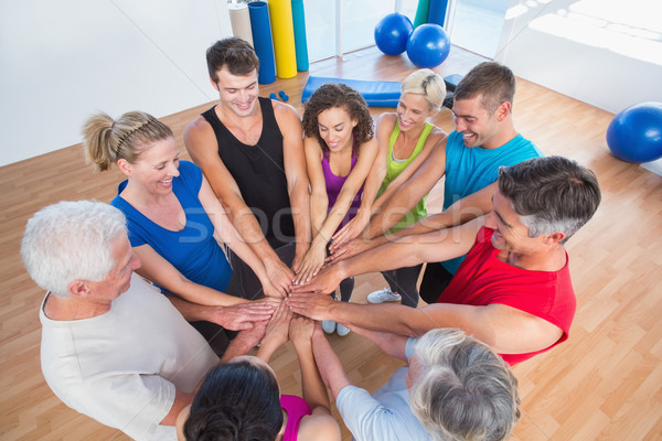 Fit people stacking hands at health club Stock photo © wavebreak_media