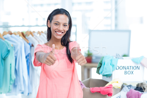 Smiling young female volunteer gesturing thumbs up Stock photo © wavebreak_media