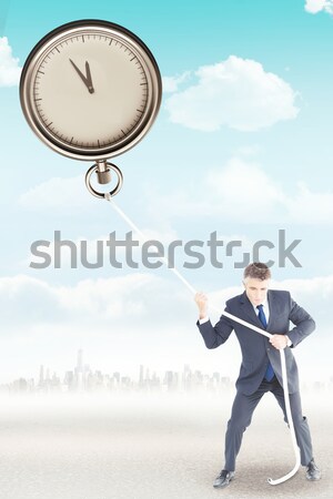  Businesswoman in suit holding a clock Stock photo © wavebreak_media