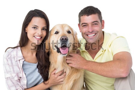 Smiling mother and son petting their golden retriever Stock photo © wavebreak_media