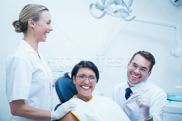 Cheerful dentist and assistant with female patient Stock photo © wavebreak_media