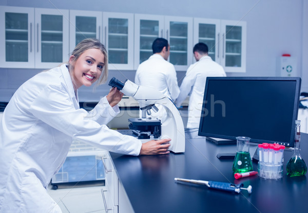 Science student working with microscope in the lab Stock photo © wavebreak_media