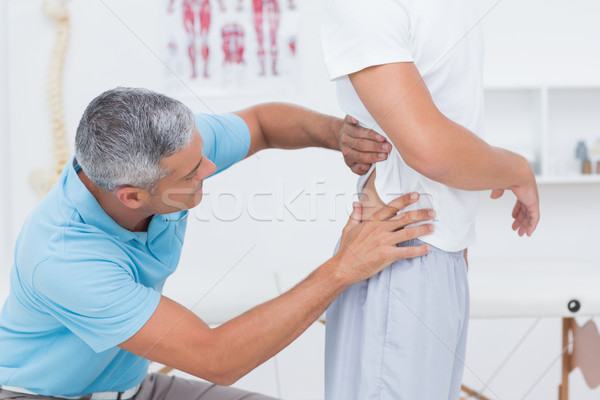 Doctor examining his patient back  Stock photo © wavebreak_media