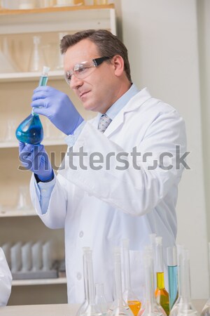 Scientist doing experimentations in flask  Stock photo © wavebreak_media