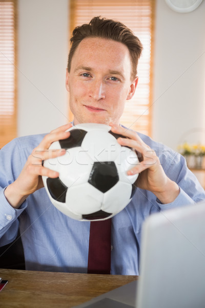 Cheerful businessman holding a soccer ball Stock photo © wavebreak_media