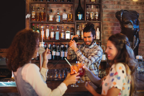 Stock photo: Bartender mixing a cocktail drink in cocktail shaker