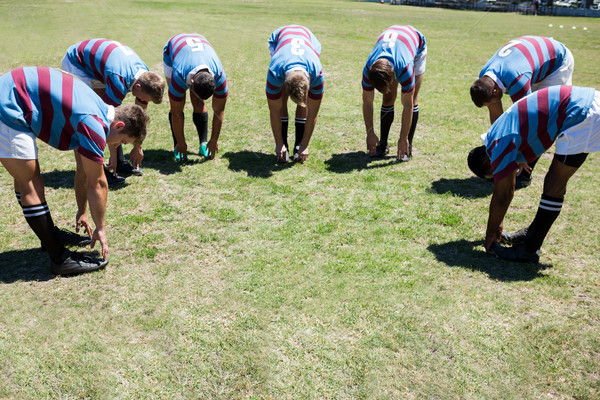 High angle view of rugby players bending while standing at grassy field Stock photo © wavebreak_media