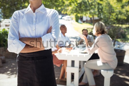 Stock photo: Friends interacting while having glass of wine in restaurant