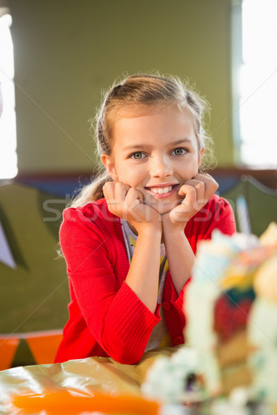 Portrait of cute girl sitting at table during birthday party Stock photo © wavebreak_media
