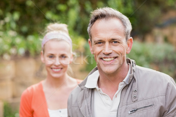 Cute couple souriant caméra jardin femme [[stock_photo]] © wavebreak_media