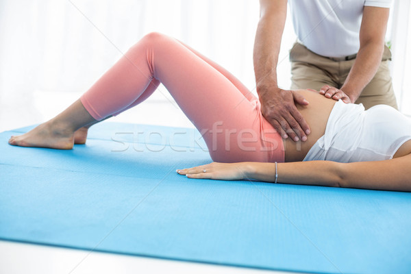 Doctor giving physiotherapy to pregnant woman Stock photo © wavebreak_media