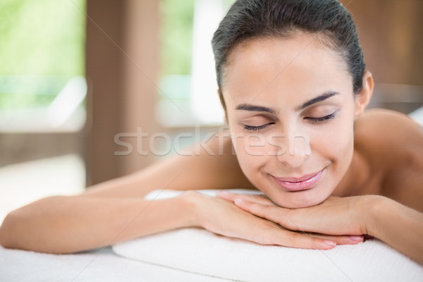Young woman smiling while relaxing on massage table Stock photo © wavebreak_media