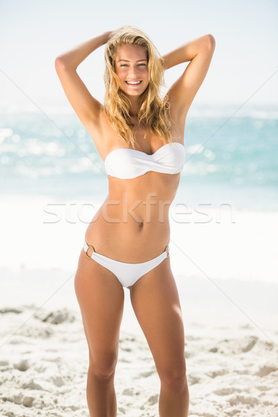 Femme souriante permanent plage femme eau [[stock_photo]] © wavebreak_media