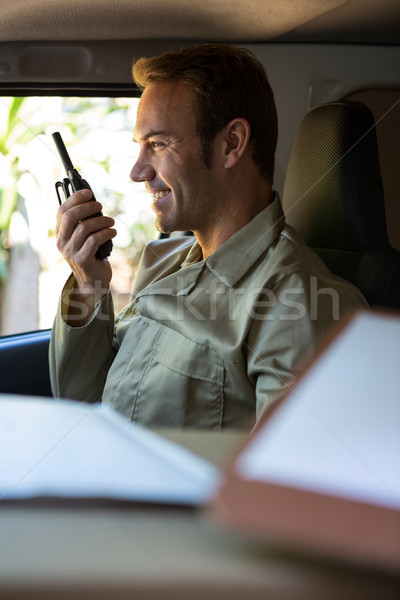 Stock photo: Delivery driver talking on walkie-talkie