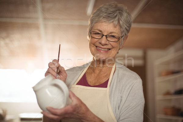 Female potter painting on jug Stock photo © wavebreak_media