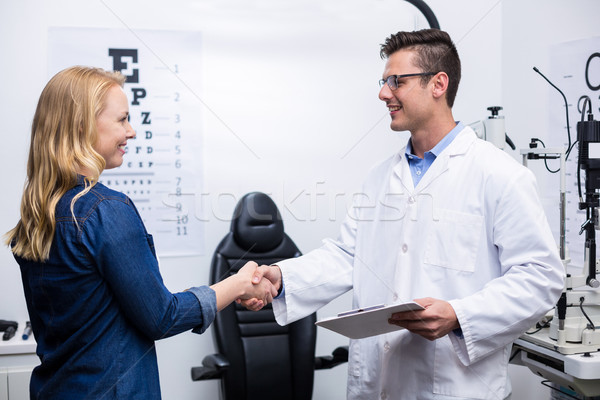 Optometrist shaking hands with female patient Stock photo © wavebreak_media