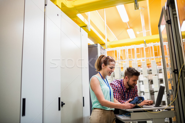 Technicians using laptop while analyzing server Stock photo © wavebreak_media