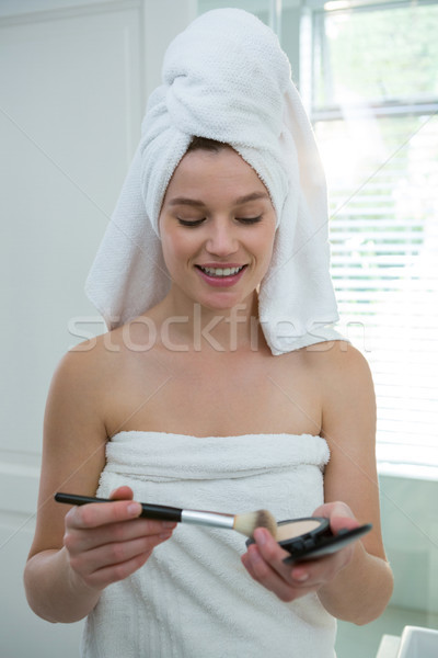 Woman holding make-up in bathroom Stock photo © wavebreak_media