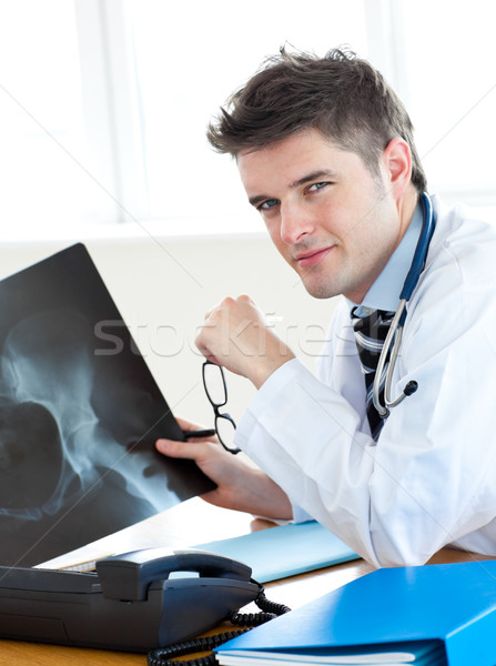 Handsome surgeon analyzing an x-ray with a female patient Stock photo © wavebreak_media