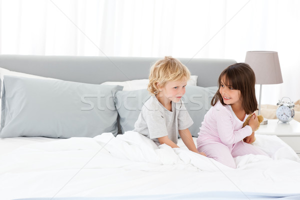 Little boy playing with his sister while sitting on a bed Stock photo © wavebreak_media