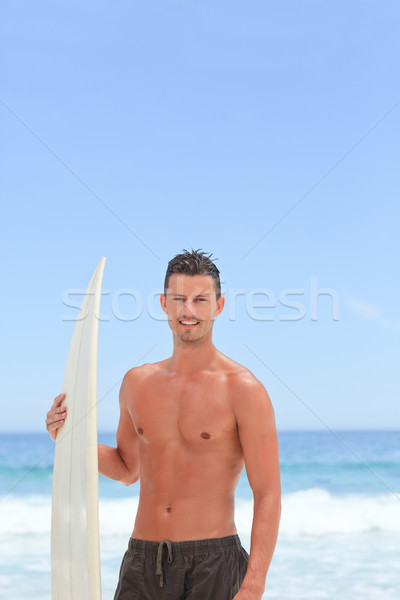 Hombre posando tabla de surf agua deporte naturaleza Foto stock © wavebreak_media