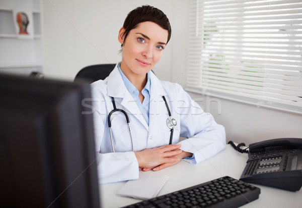 Serious female doctor looking at the camera in her office Stock photo © wavebreak_media