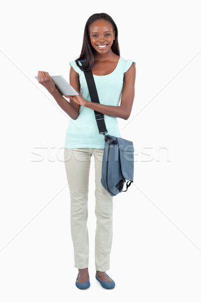 Smiling young student with her scratchpad against a white background Stock photo © wavebreak_media