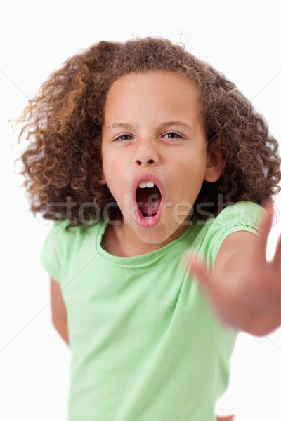 Portrait of an angry girl saying stop with her hand against a white background Stock photo © wavebreak_media