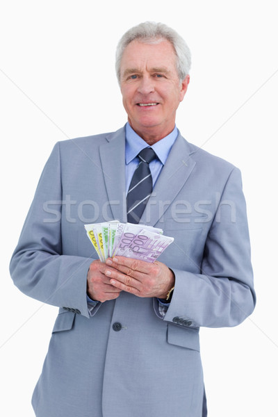 Smiling mature tradesman with bank notes in his hands against a white background Stock photo © wavebreak_media