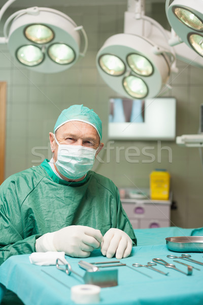 Surgeon sitting in front of surgical tools in a surgical room Stock photo © wavebreak_media