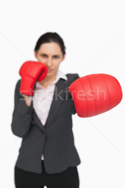 Brunette wearing red gloves punching against white background Stock photo © wavebreak_media