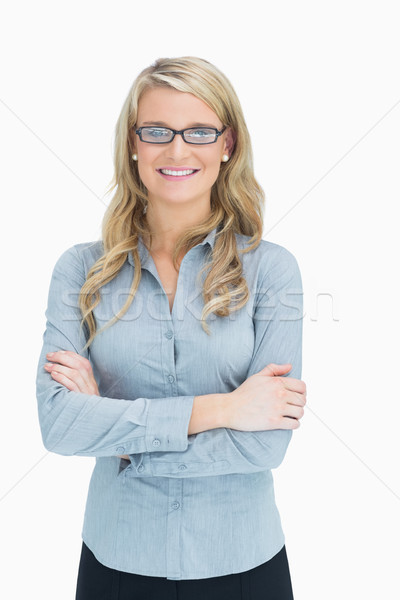 Woman with glasses crossing her arms while smiling Stock photo © wavebreak_media