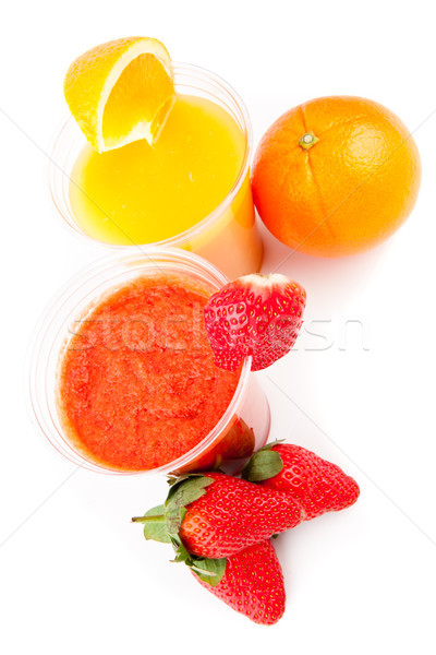 Orange and strawberry juice standing against white background Stock photo © wavebreak_media