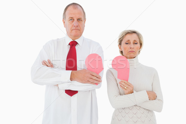 Older couple standing holding broken pink heart Stock photo © wavebreak_media