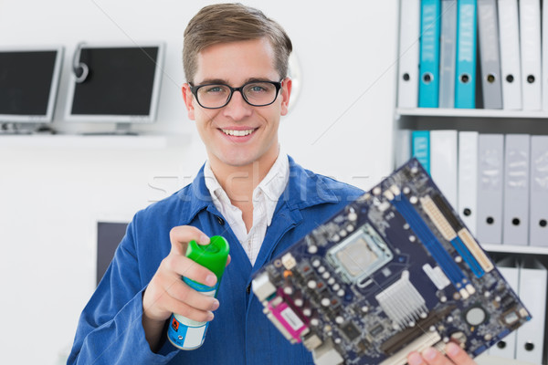 Souriant technicien travail brisé cpu bureau [[stock_photo]] © wavebreak_media