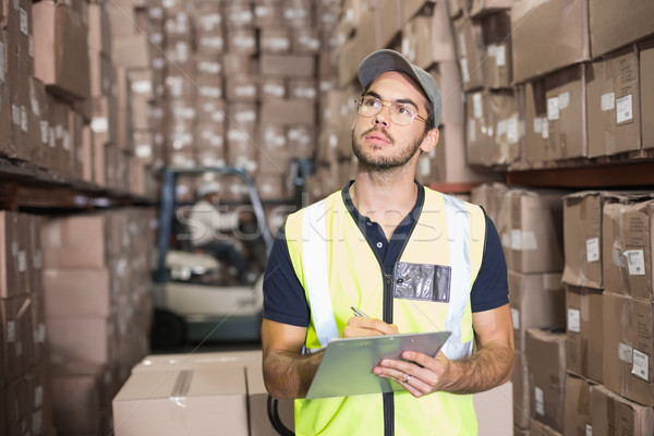 Warehouse worker checking his list Stock photo © wavebreak_media