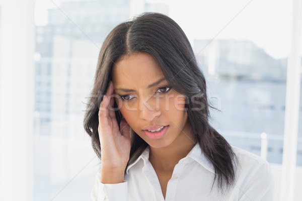 Businesswoman suffers a severe headache Stock photo © wavebreak_media