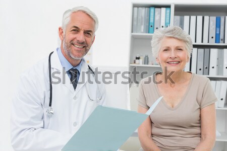 Patient showing thumbs up sign while standing with doctor Stock photo © wavebreak_media