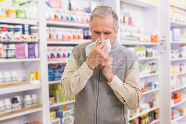 Sick customer sneezing on tissue Stock photo © wavebreak_media
