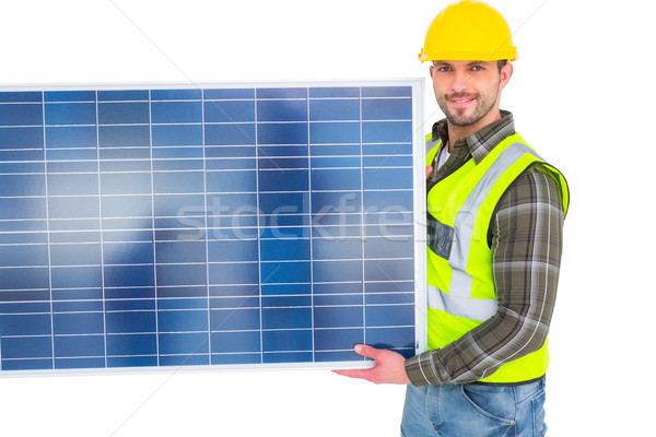 Handyman in protective clothing carrying solar panel Stock photo © wavebreak_media