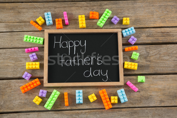 Overhead view of slate with text amidst colorful toy blocks on table Stock photo © wavebreak_media