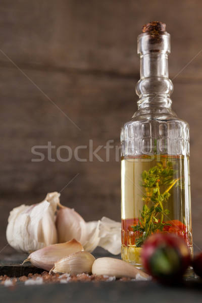 Close up of herb with oil in container by garlic Stock photo © wavebreak_media