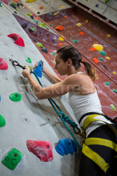 Woman practicing rock climbing in fitness studio Stock photo © wavebreak_media