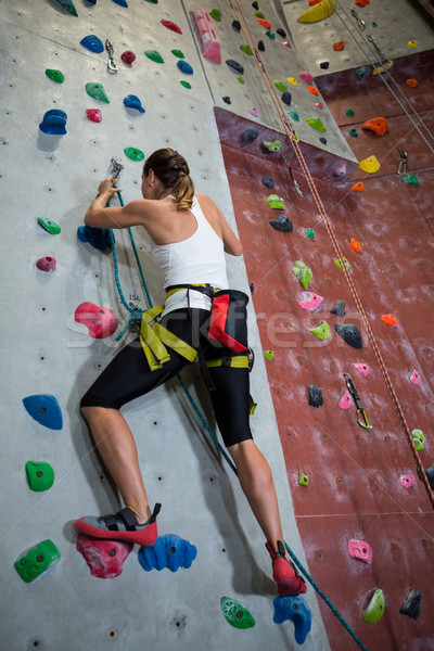 Woman practicing rock climbing in fitness studio Stock photo © wavebreak_media