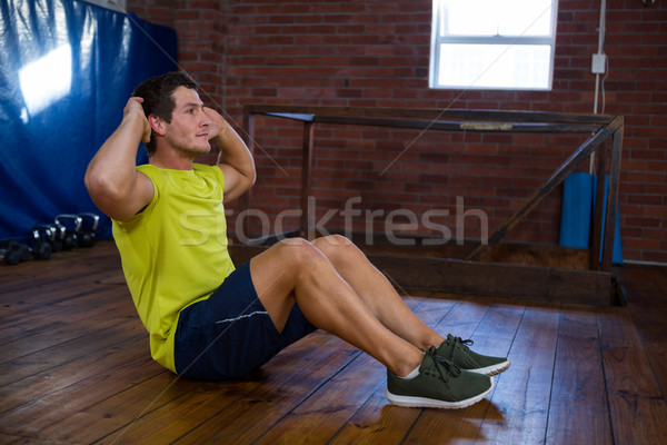 Stock photo: Determined man performing crunches