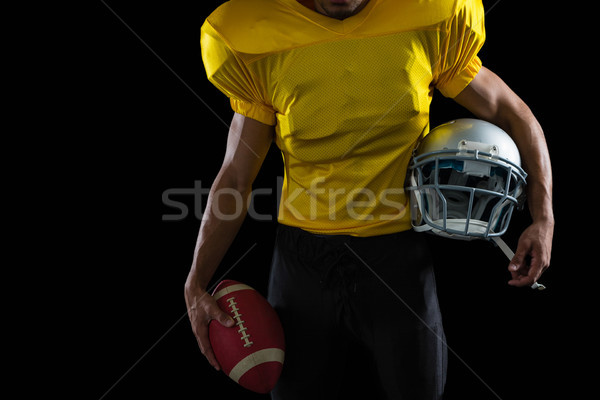 Amerikai futballista tart labda fej viselet Stock fotó © wavebreak_media
