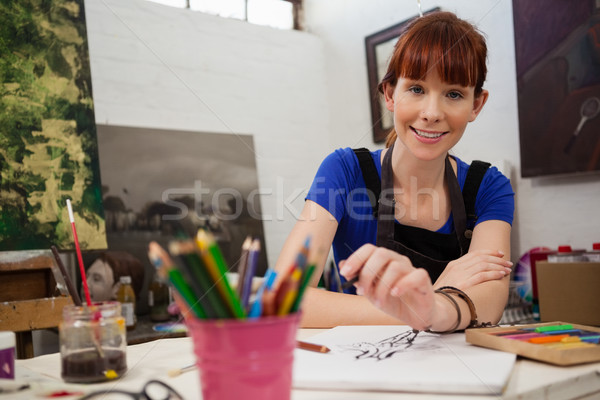 Beautiful woman sketching in drawing book Stock photo © wavebreak_media